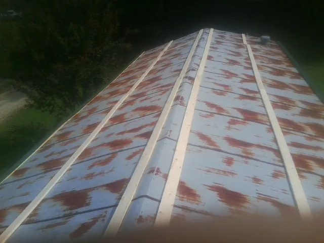 Rusted metal roof panels with new wood purlins before replacement — Storm Damage Roof Repair in Mableton by Roofing Brothers